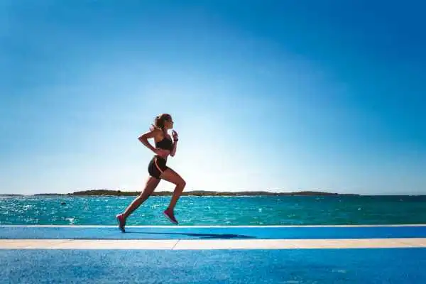 Woman running showing strong leg muscle Highworth